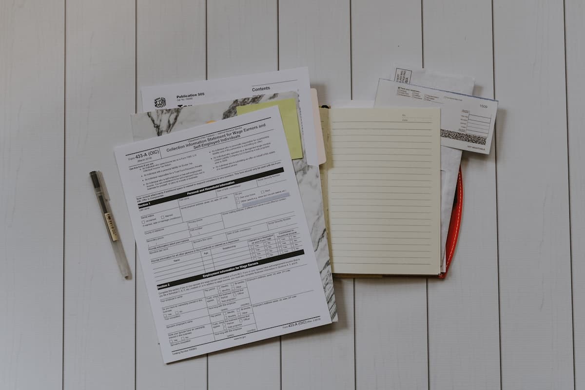 Stack of insurance paperwork and pen on a desk