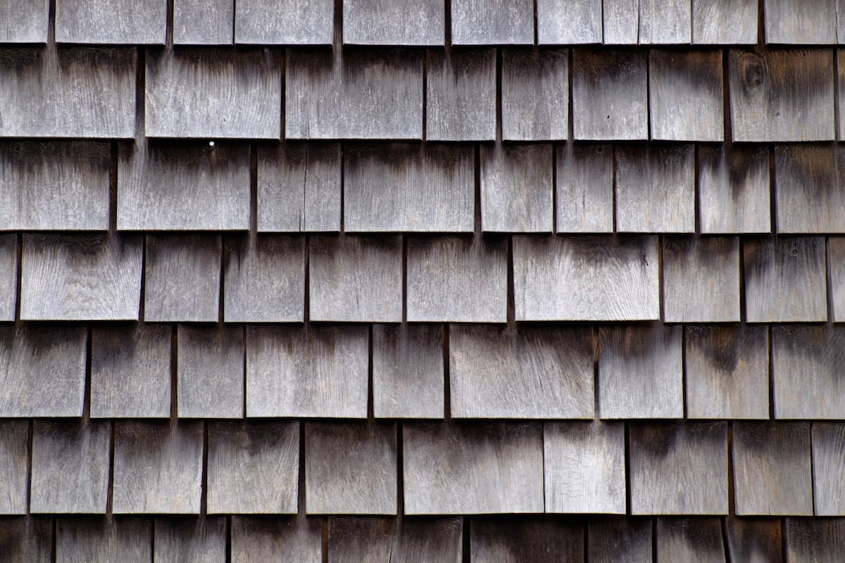 Overlapping brown clay roof tiles in a geometric pattern
